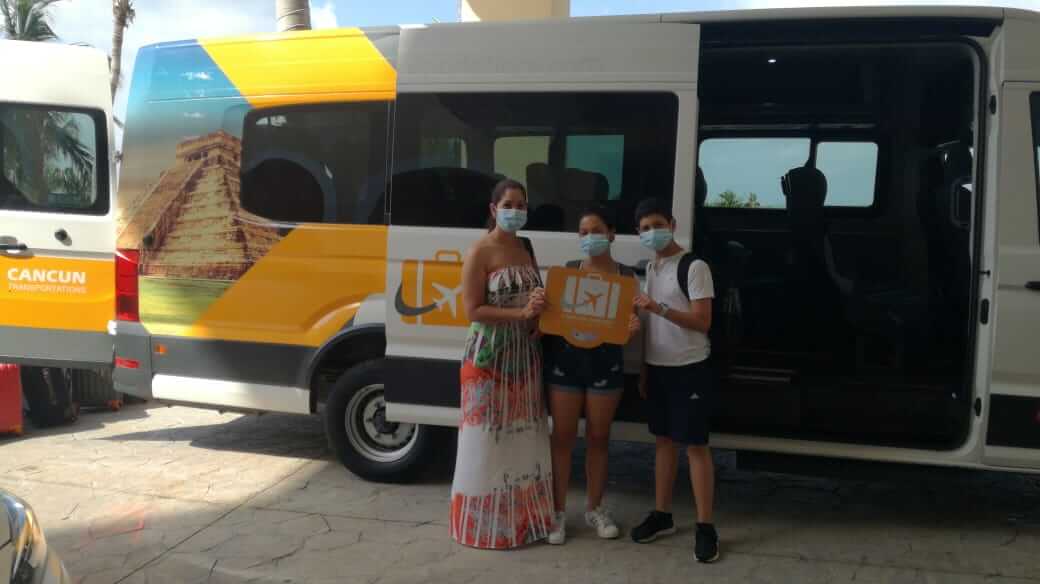 Small family arriving at their accommodation by Group Transportation van