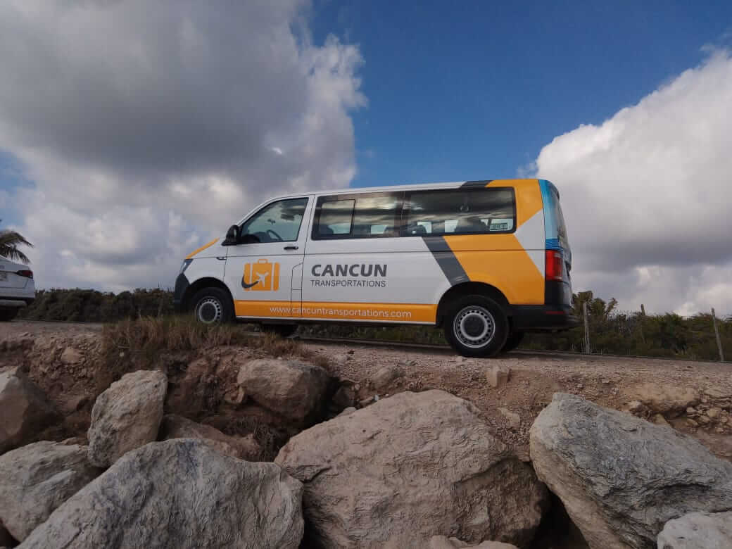 Private Transportation van parked around some rocks by the coast