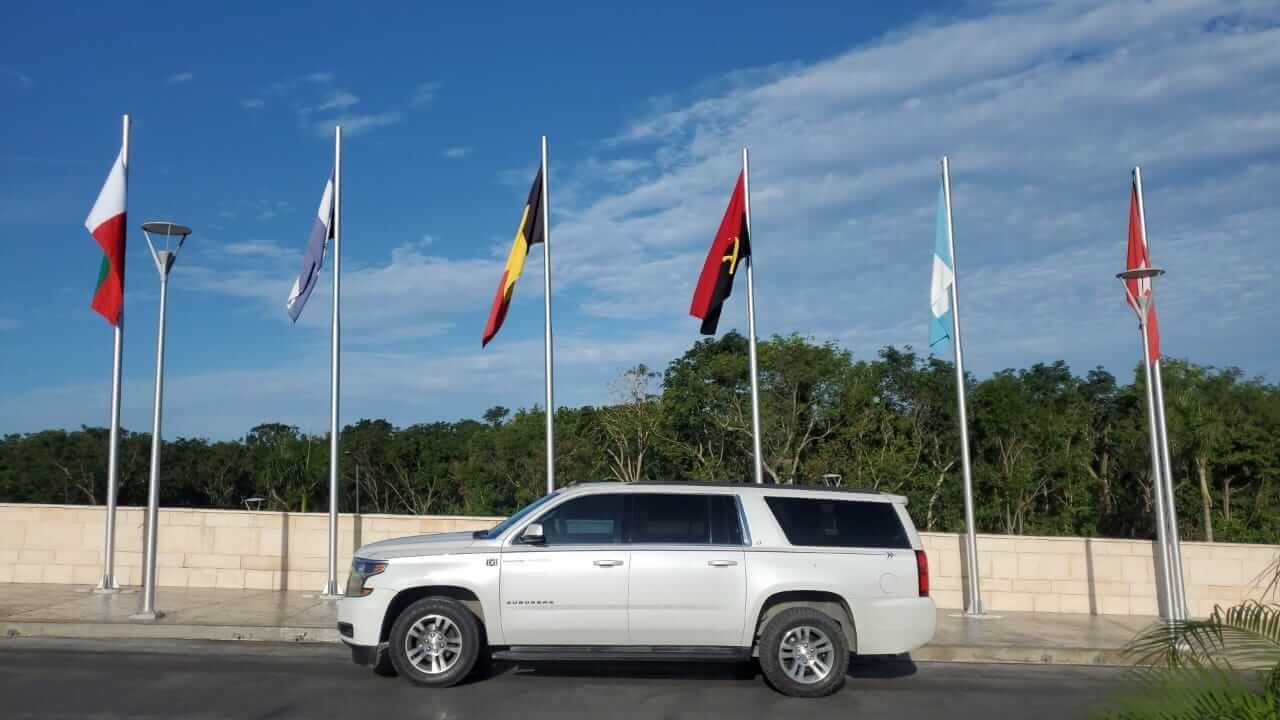 Luxury SUV parked near flags