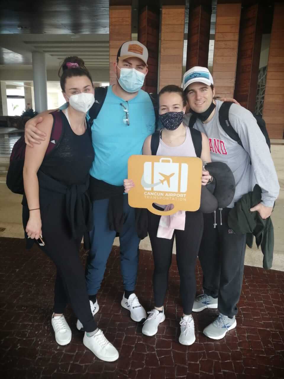 Group of four friends arriving at their hotel