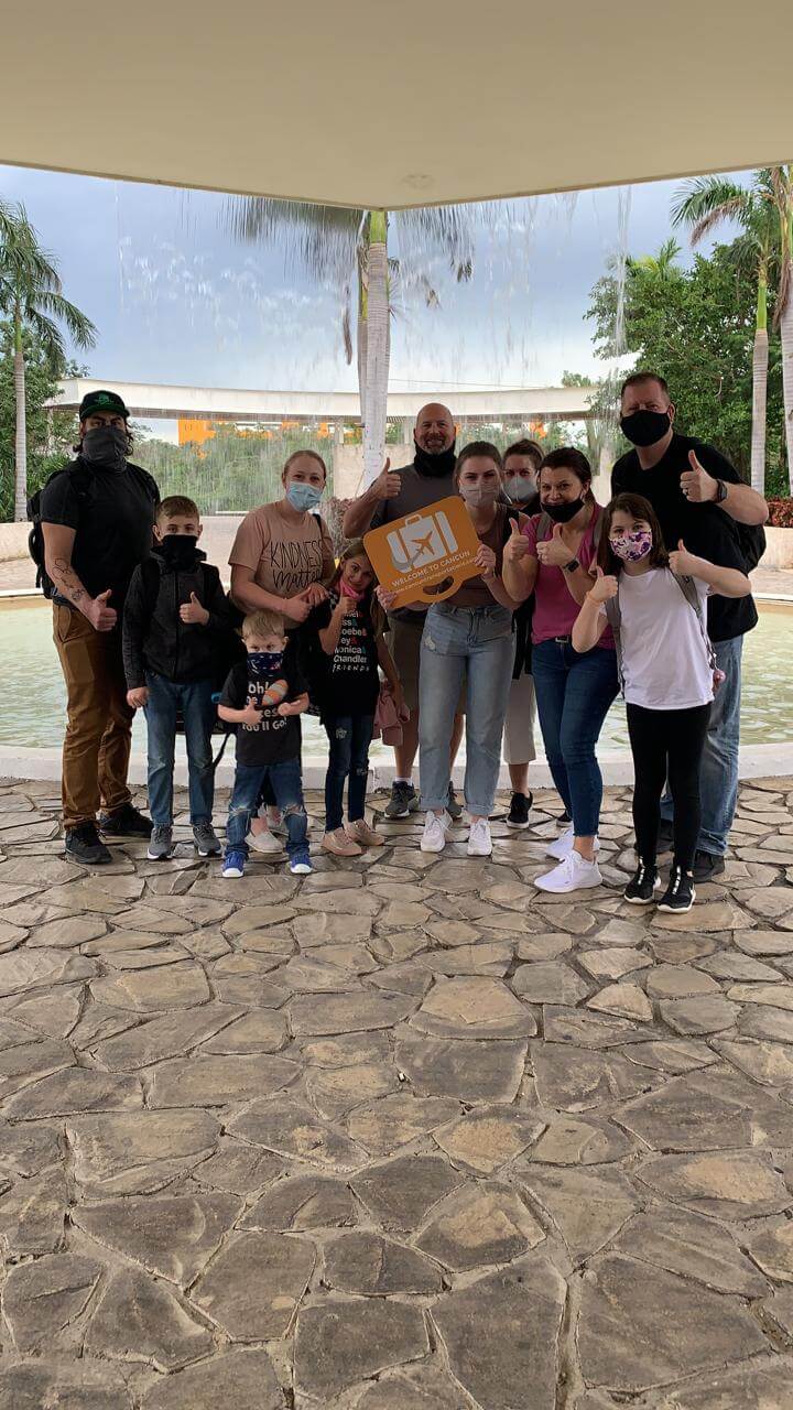 Big family arriving at their hotel after a Group Transportation service