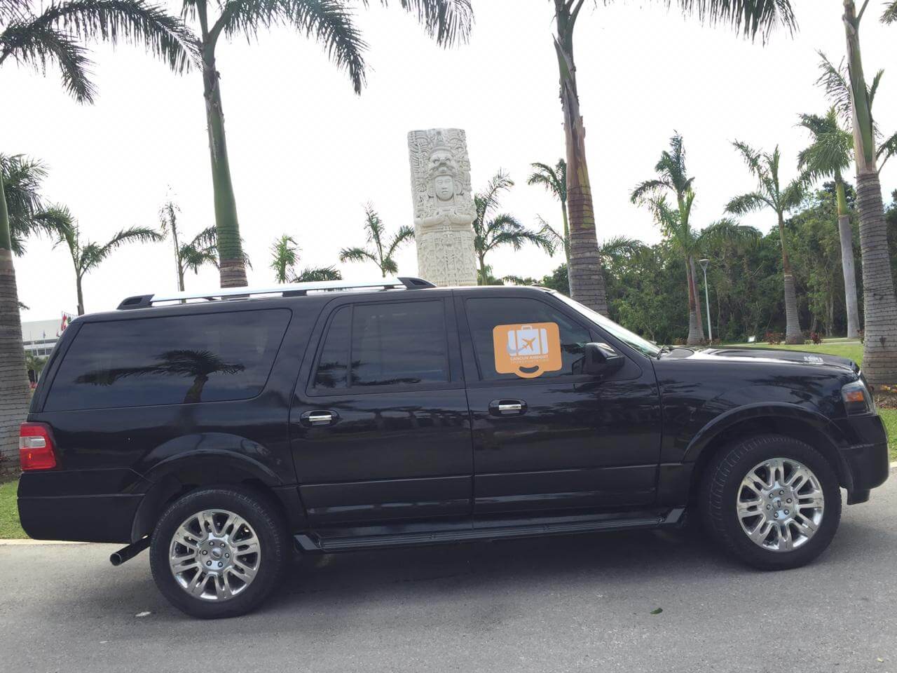 Board with logo displayed in black luxury SUV window